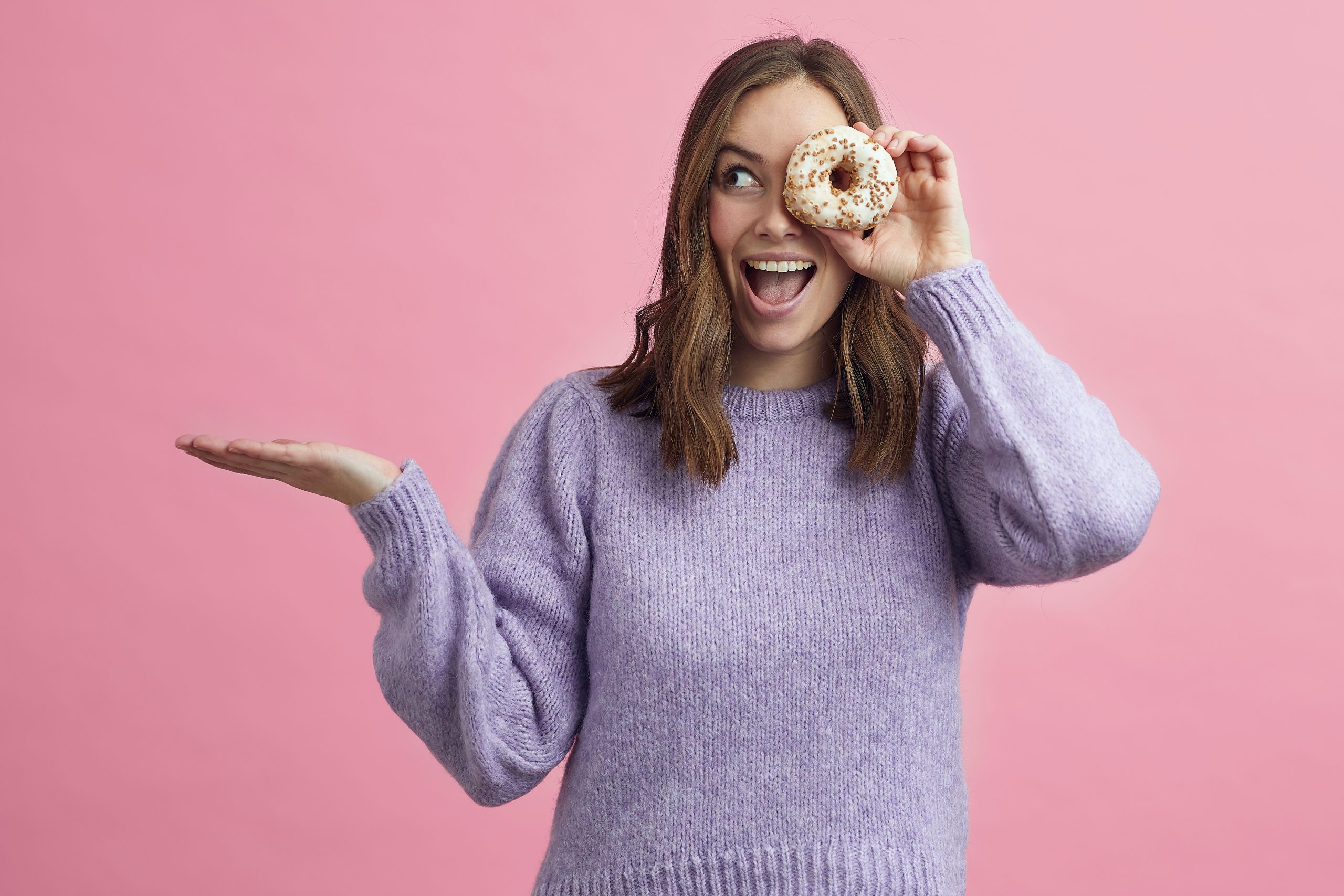 Cute,Attractive,Girl,Holding,A,Donuts,Up,Infront,Of,Her