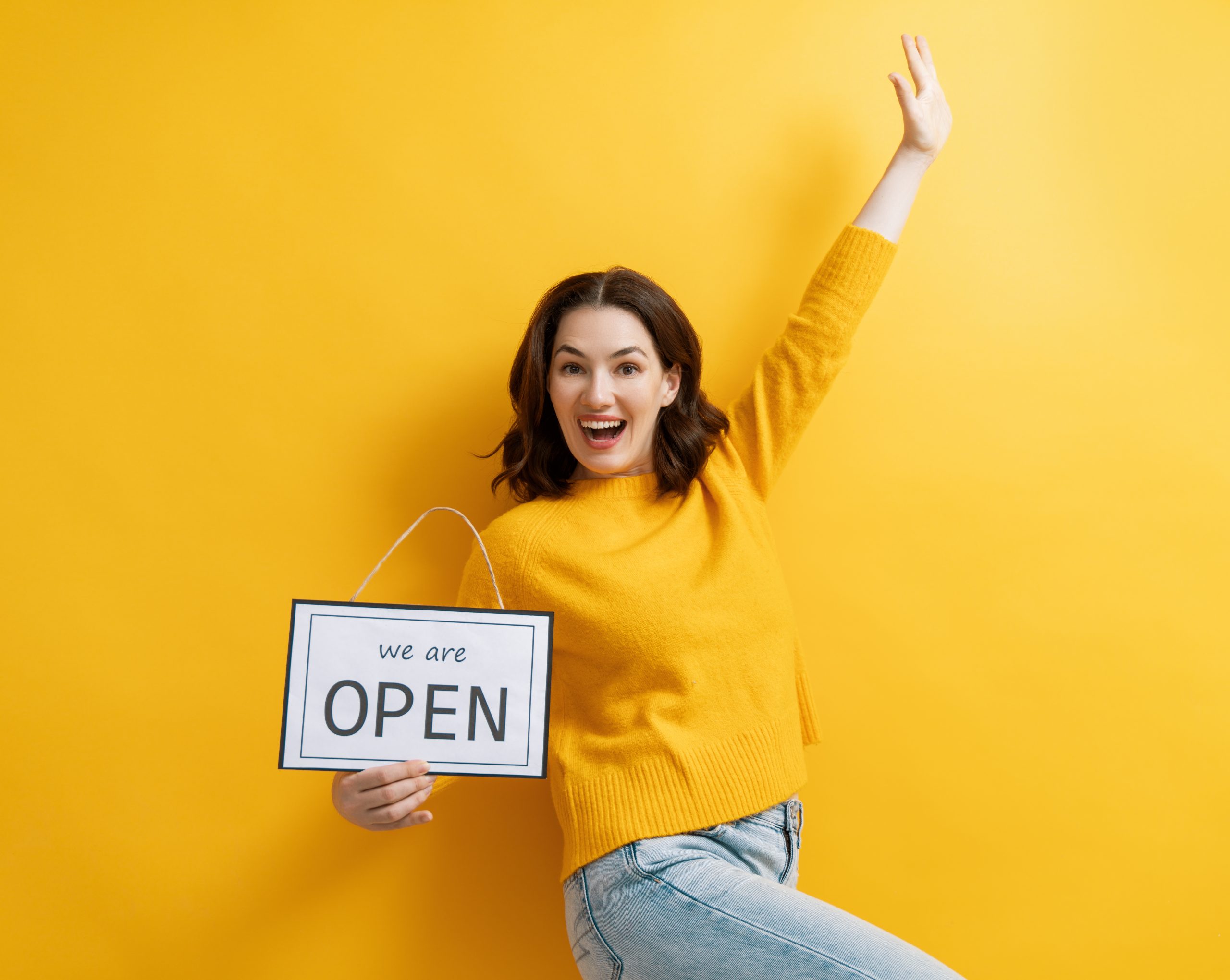 Small,Business,Owner,Smiling,And,Holding,The,Sign,For,The