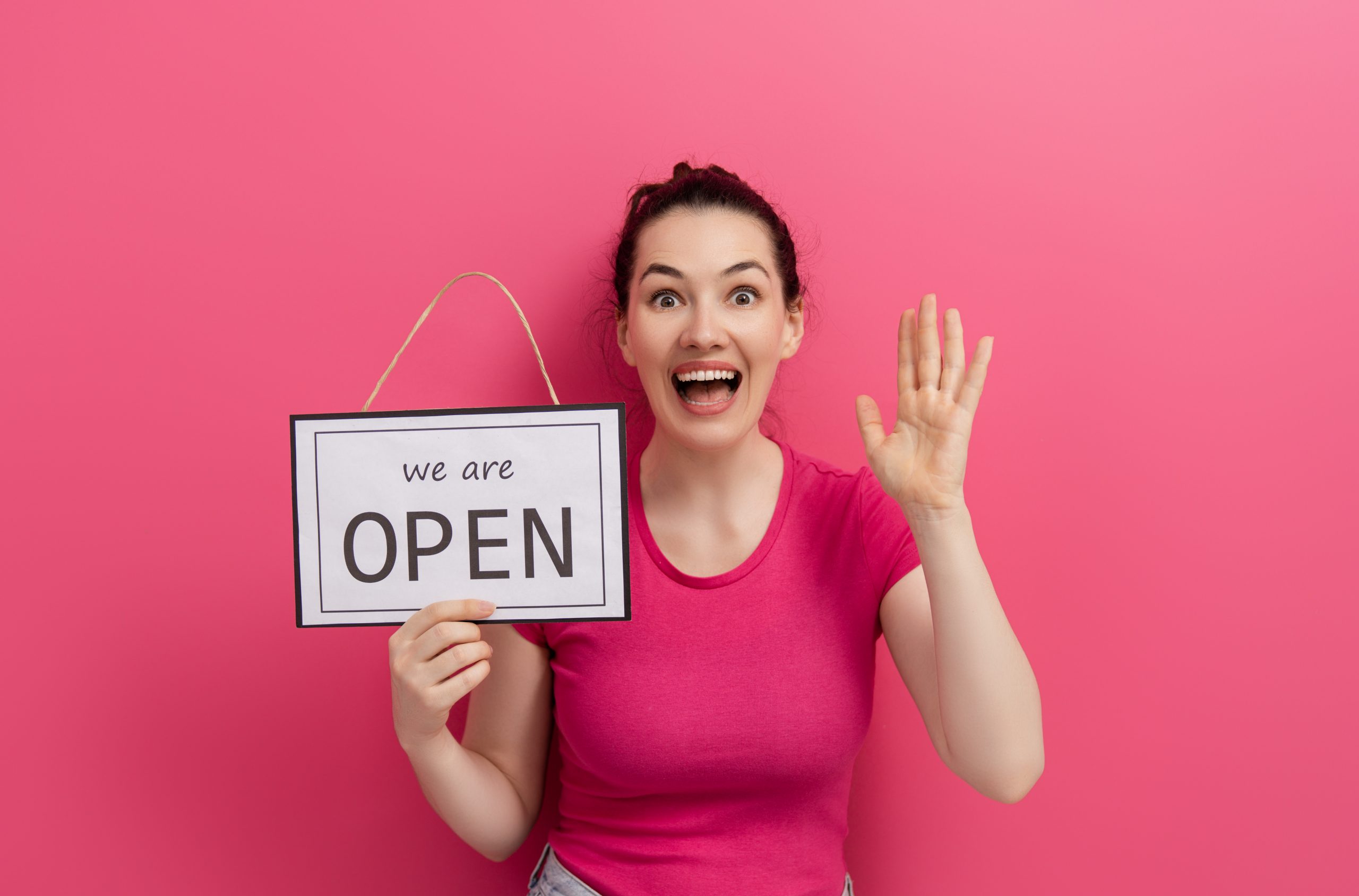 Small,Business,Owner,Smiling,And,Holding,The,Sign,For,The